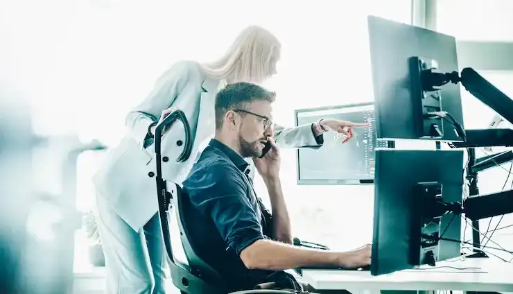 stock broker business team trading online watching charts data analyses multiple computer 561846 658 compressed